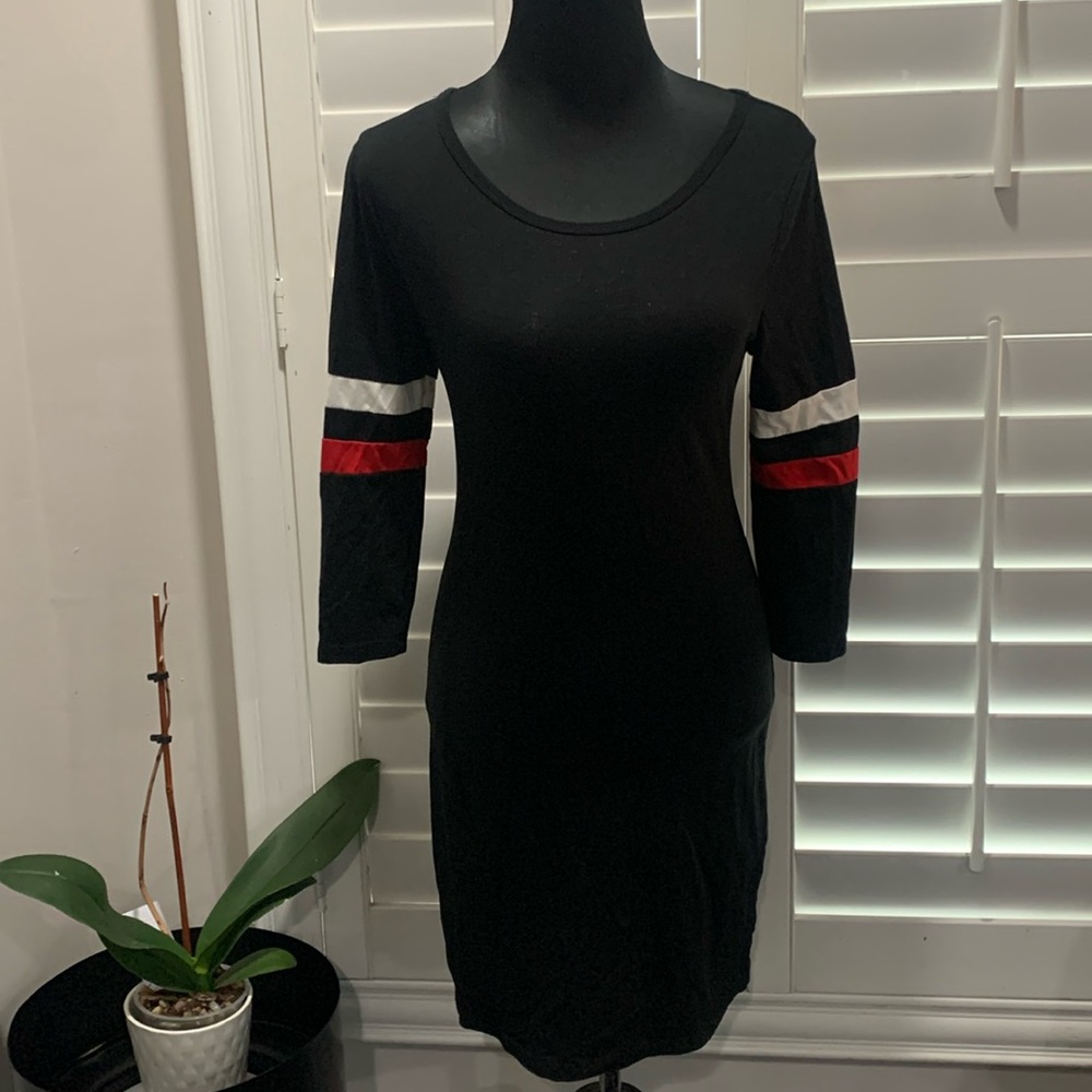 Heart and Hips Black mini dress with red and black strip on sleeve. Size L